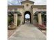 Beautifully landscaped clubhouse entrance with archway leading to community pool at 16013 S Desert Foothills Pkwy # 2056, Phoenix, AZ 85048