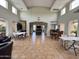 Expansive game room featuring high ceilings, abundant natural light, and several tables for various activities at 16013 S Desert Foothills Pkwy # 2056, Phoenix, AZ 85048