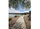 Scenic lakeside path with lush landscaping and views of beautiful townhome community at 16013 S Desert Foothills Pkwy # 2056, Phoenix, AZ 85048