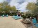 Community pool deck with lounge chairs and well-maintained landscaping at 16013 S Desert Foothills Pkwy # 2056, Phoenix, AZ 85048