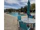 Relaxing poolside seating area with table, chairs, and umbrella at community pool at 16013 S Desert Foothills Pkwy # 2056, Phoenix, AZ 85048