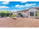 Spacious backyard with gravel landscaping, patio area, and lush greenery at 16246 W Talara Way, Surprise, AZ 85374
