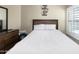 Simple bedroom with bed, dresser, decor, and window with bright sunlight at 16246 W Talara Way, Surprise, AZ 85374