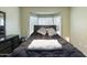 Comfortable bedroom featuring a bay window with white shutters, a dark wood bed frame, and neutral-toned walls at 16246 W Talara Way, Surprise, AZ 85374