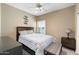 Relaxing bedroom with ceiling fan, plantation shutters, and a bedside table at 16246 W Talara Way, Surprise, AZ 85374