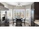 Inviting dining nook bathed in natural light, showcasing stainless steel appliances and a cozy ambiance at 16246 W Talara Way, Surprise, AZ 85374