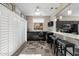 Charming dining area with a bar and seating adjacent to the kitchen with stainless steel appliances at 16246 W Talara Way, Surprise, AZ 85374