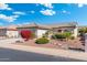 Charming single-story home boasts well-manicured landscaping, a cozy front yard, and a welcoming entrance for instant curb appeal at 16246 W Talara Way, Surprise, AZ 85374