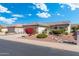 Well-maintained home with desert landscaping, mature trees, and a paved driveway at 16246 W Talara Way, Surprise, AZ 85374