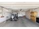Spacious garage with a golf cart, ample storage cabinets, and functional lighting fixtures at 16246 W Talara Way, Surprise, AZ 85374