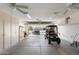 Spacious garage with ample storage, golf cart, and view to an exterior with a car at 16246 W Talara Way, Surprise, AZ 85374