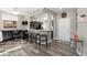 Modern kitchen with dark cabinetry, pendant lights, and a breakfast bar with seating at 16246 W Talara Way, Surprise, AZ 85374