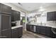 Well-equipped kitchen with stainless steel appliances, stone countertops, and ample cabinet space at 16246 W Talara Way, Surprise, AZ 85374