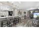 Open-concept space with bar seating, modern lighting, and stylish decor for entertaining guests at 16246 W Talara Way, Surprise, AZ 85374