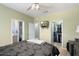 Bright main bedroom featuring a ceiling fan, ensuite access, and closet storage at 16246 W Talara Way, Surprise, AZ 85374