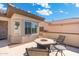 Cozy patio features a fire pit, outdoor seating, and a stylish concrete design, perfect for relaxing and entertaining at 16246 W Talara Way, Surprise, AZ 85374