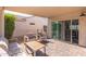 Covered patio with a comfortable seating area overlooking the backyard at 16246 W Talara Way, Surprise, AZ 85374