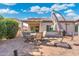 Outdoor patio with a covered seating area, BBQ, and well-maintained brick pavers at 16246 W Talara Way, Surprise, AZ 85374