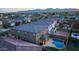Aerial view of a home with a pool and covered patio, nestled in a well-maintained neighborhood with mountain views at 17424 W Willow Ave, Surprise, AZ 85388