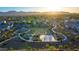 Aerial view of a community park with a playground, basketball court, and walking paths, perfect for outdoor recreation at 17424 W Willow Ave, Surprise, AZ 85388