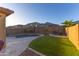 Serene backyard featuring a custom pool, artificial turf, and a cozy seating area for relaxing evenings at 17424 W Willow Ave, Surprise, AZ 85388