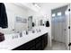 Bright bathroom boasts double sinks, vanity, and an adjacent shower offering a clean, functional space at 17424 W Willow Ave, Surprise, AZ 85388