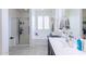 Fresh bathroom boasts a soaking tub, shower, black cabinets, and neutral tile flooring at 17424 W Willow Ave, Surprise, AZ 85388