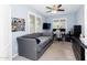 Comfortable bedroom features a daybed, ceiling fan, and a desk area perfect for work or study at 17424 W Willow Ave, Surprise, AZ 85388