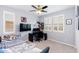 This bedroom is brightly lit by natural light from shuttered windows and offers space for work and rest at 17424 W Willow Ave, Surprise, AZ 85388