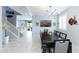 Elegant dining room features a large table, modern lighting, and access to the living area at 17424 W Willow Ave, Surprise, AZ 85388