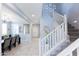 Bright entryway showcasing stairs with white railings and views into the dining and living areas at 17424 W Willow Ave, Surprise, AZ 85388