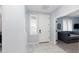 Bright entryway with tiled floors, a white front door, and a glimpse into a cozy living space at 17424 W Willow Ave, Surprise, AZ 85388