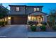 Inviting home with a large two-car garage, stone detailing, and lush landscaping enhancing its curb appeal at 17424 W Willow Ave, Surprise, AZ 85388