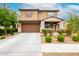 Charming two-story home with a well-manicured front yard and a two-car garage, perfect for suburban living at 17424 W Willow Ave, Surprise, AZ 85388