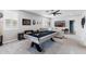 Spacious game room with a pool table, TV, and comfortable seating area at 17424 W Willow Ave, Surprise, AZ 85388