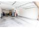 Spacious garage with overhead door, room for two cars, and extra storage space at 17424 W Willow Ave, Surprise, AZ 85388