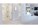 Bright hallway showcases tile flooring, neutral walls, and access to multiple rooms at 17424 W Willow Ave, Surprise, AZ 85388