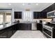 Open kitchen featuring granite countertops, stainless steel appliances, and ample cabinet space at 17424 W Willow Ave, Surprise, AZ 85388