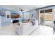 Inviting living room with tile floors, a ceiling fan, and sliding glass doors to the pool area at 17424 W Willow Ave, Surprise, AZ 85388