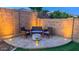 Backyard lounge area with a patio, an outdoor seating set, desert landscaping, and artificial turf at 17424 W Willow Ave, Surprise, AZ 85388