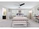 Serene main bedroom with a neutral color scheme, plantation shutters, and a decorative bench at the foot of the bed at 17424 W Willow Ave, Surprise, AZ 85388