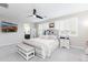 Bright main bedroom boasts natural light, neutral walls, ceiling fan, and cozy furnishings at 17424 W Willow Ave, Surprise, AZ 85388