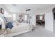 Spacious main bedroom suite featuring a ceiling fan, neutral walls, and ensuite bathroom at 17424 W Willow Ave, Surprise, AZ 85388