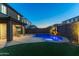 Amazing backyard with a sparkling pool, fire pit, an outdoor kitchen providing space for luxurious outdoor living at 17424 W Willow Ave, Surprise, AZ 85388