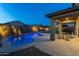 Inviting backyard with a sparkling pool, covered patio, and a cozy fire pit, perfect for outdoor relaxation and entertaining at 17424 W Willow Ave, Surprise, AZ 85388