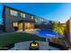 Large backyard features a sparkling pool, turf and seating area, perfect for relaxation at 17424 W Willow Ave, Surprise, AZ 85388
