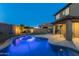 Inviting backyard with a sparkling pool, covered patio, and a cozy fire pit, perfect for outdoor relaxation and entertaining at 17424 W Willow Ave, Surprise, AZ 85388