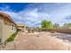 Expansive backyard features a built-in barbecue, fire pit, and ample room for outdoor activities at 18249 W Mauna Loa Ln, Surprise, AZ 85388
