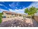 Large backyard with fire pit, desert landscaping, BBQ and plenty of room for entertaining at 18249 W Mauna Loa Ln, Surprise, AZ 85388
