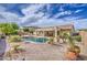 Lush backyard with sparkling pool and desert landscaping offers a private outdoor retreat at 18249 W Mauna Loa Ln, Surprise, AZ 85388